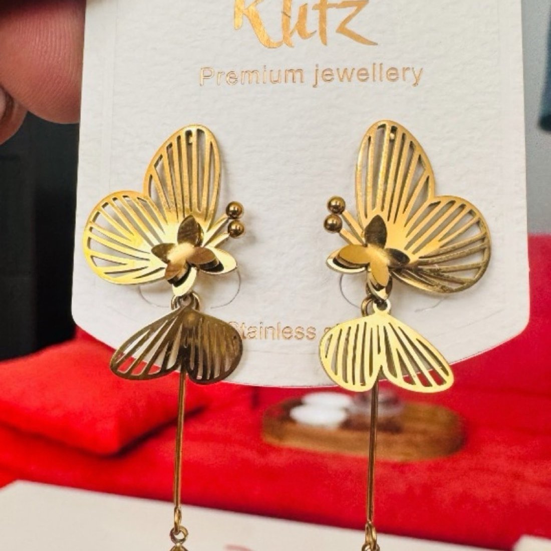 Original mobile photo of the same earrings on a retail display card